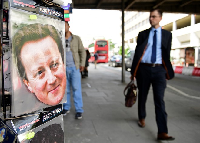 Novelty face masks including one of British Prime Minister David Cameron, are displayed for sale on a street vendor's stall in London, on June 24, 2016. Britain voted to break away from the European Union on June 24, toppling Prime Minister David Cameron and dealing a thunderous blow to the 60-year-old bloc that sent world markets plunging. / AFP PHOTO / LEON NEAL