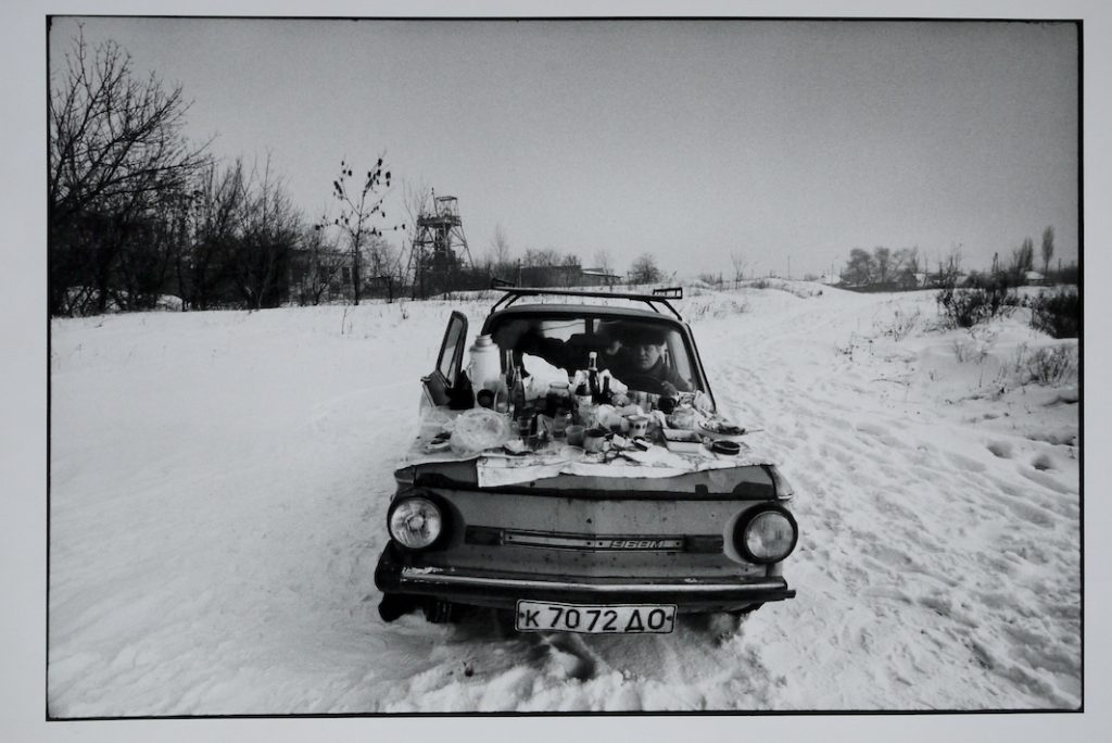 A family sit's in their car to keep warm on New Years Day 1992.  Their car is know to local's as 'The coffin on wheels’ The temperature outside was -15C. Donetsk, Ukraine.