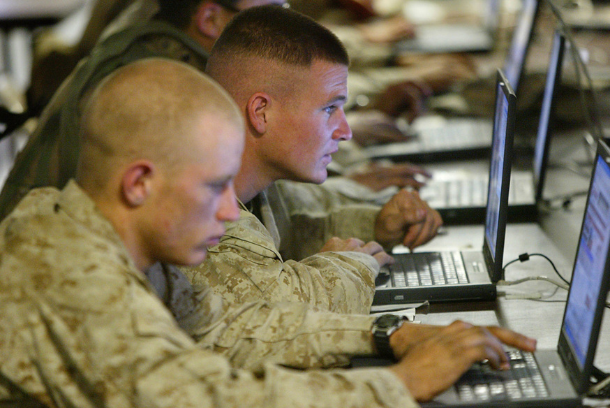 US marines from the First Battalion, 5th Marines, Bravo Company, browse the internet at camp Mercury 25 April 2004 in the restive city of Fallujah. The latest casualties brought to 717 the American military death toll since the US-led invasion of Iraq in March last year, including 519 killed in action, most of them fighting against insurgents.  AFP PHOTO/Nicolas ASFOURI