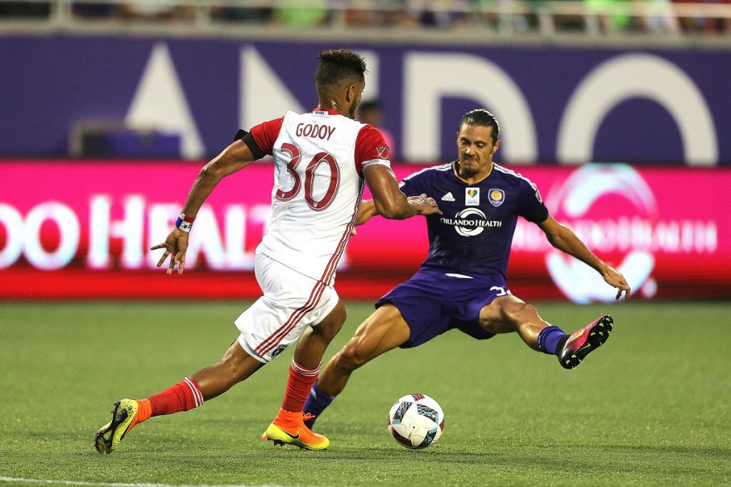 ORLANDO, FL - JUNE 18:  Anibal Godoy #30 of San Jose Earthquakes runs past a leaping Adrian Winter #32 of Orlando City SC during an MLS soccer match between the San Jose Earthquakes and the Orlando City SC at Camping World Stadium on June 18, 2016 in Orlando, Florida. (Photo by Alex Menendez/Getty Images)