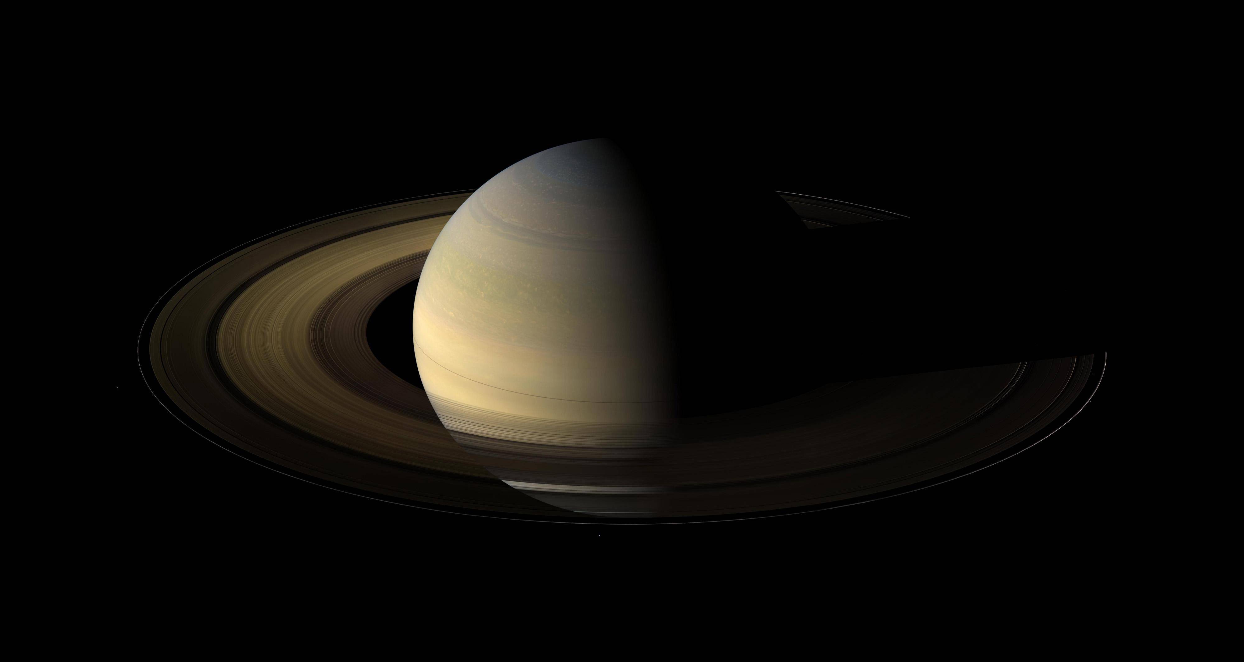 This NASA handout image obtained October 19, 2009 shows Saturn during an equinox captured by the robot explorer Cassini. The images comprising the mosaic, taken over about eight hours, were extensively processed before being joined together. With no enhancement, the rings would be essentially invisible in this mosaic. To improve their visibility, the dark right half of the rings has been brightened relative to the brighter left half by a factor of three, and then the whole ring system has been brightened by a factor of 20 relative to the planet. So the dark half of the rings is 60 times brighter, and the bright half 20 times brighter, than they would have appeared if the entire system, planet included, could have been captured in a single image.The images were taken on August 12, 2009, beginning about 1.25 days after exact equinox, using the red, green and blue spectral filters of the wide angle camera and were combined to create this natural color view. The images were obtained at a distance of approximately 526,000 miles from Saturn and at a Sun-Saturn-spacecraft, or phase, angle of 74 degrees. Image scale is 31 miles per pixel. AFP PHOTO/NASA/JPL/SPACE/RESTRICTED TO EDITORIAL USE / AFP PHOTO / NASA / HO