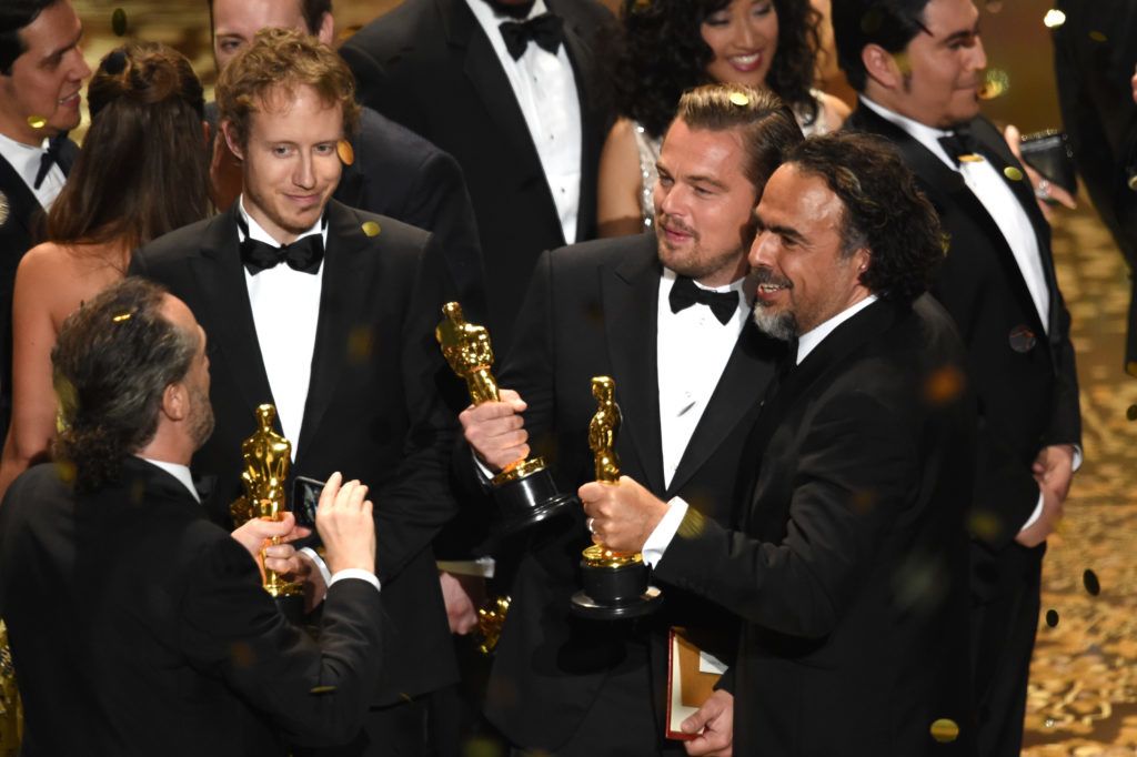 HOLLYWOOD, CA - FEBRUARY 28:  Director Laszlo Nemes (2nd L), winner of Best Foreign Language Film for 'Son of Saul,' looks on as cinematographer Emmanuel Lubezki (L), winner of Best Cinematography for 'The Revenant,' takes a photo of actor Leonardo DiCaprio (2nd R), winner of Best Actor for 'The Revenant,' and director Alejandro Gonzalez Inarritu (R), winner of Best Director for 'The Revenant,' onstage during the 88th Annual Academy Awards at the Dolby Theatre on February 28, 2016 in Hollywood, California.  (Photo by Kevin Winter/Getty Images)