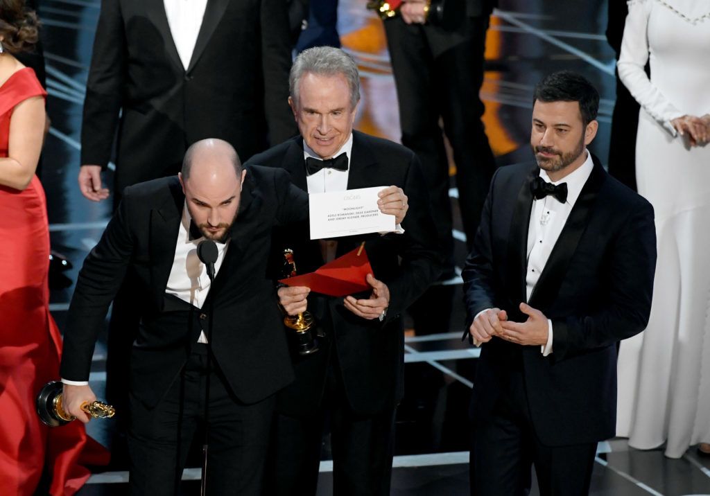 HOLLYWOOD, CA - FEBRUARY 26:  'La La Land' producer Jordan Horowitz holds up the winner card reading actual Best Picture winner 'Moonlight' with actor Warren Beatty and host Jimmy Kimmel onstage during the 89th Annual Academy Awards at Hollywood & Highland Center on February 26, 2017 in Hollywood, California.  (Photo by Kevin Winter/Getty Images)