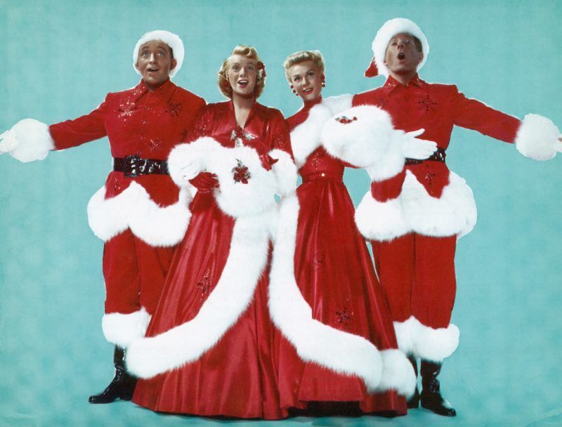 (Original Caption) Left to right are; Actor Bing Crosby, Actresses Rosemary Clooney and Vera Ellen, and Actor Danny Kaye, dressed in Christmas colors as they sing during the 1954 Paramount production of "White Christmas." Undated movie still. (Photo by George Rinhart/Corbis via Getty Images)