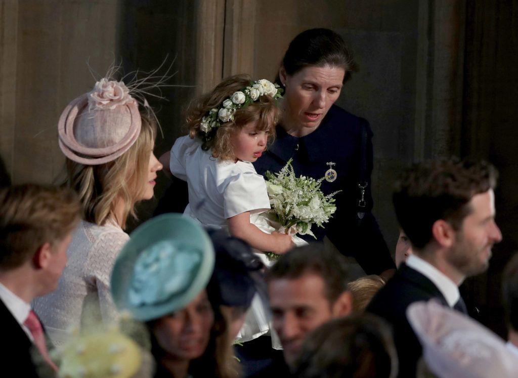 WINDSOR, UNITED KINGDOM - MAY 19: Royal Nanny Maria Teresa Turrion Borrallo comforts bridesmaid Zalie Warren inside the entrance to the chapel before the wedding of Prince Harry to Meghan Markle in St George's Chapel at Windsor Castle on May 19, 2018 in Windsor, England. (Photo by Owen Humphreys - WPA Pool/Getty Images)