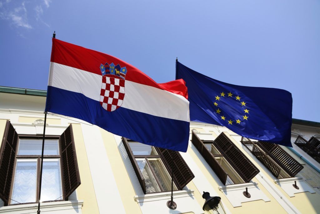 A Croatian national flag and Europe flag are seen at the croatian government building in Zagreb city, Croatia, on 24 June 2017. (Photo by Alen Gurovic/NurPhoto)