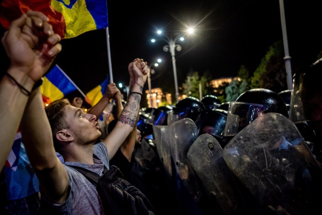Romanians take part in a demonstration in front of the Romanian Government headquarters, in Bucharest August 10, 2018, to protest against the government.
Romanian police used water cannon and tear gas to disperse anti-corruption protesters in Bucharest after tens of thousands rallied to call on the leftwing government to resign. Local media said between 50,000 to 80,000 people turned out for the protest, including many Romanian expatriates who returned home to show their anger at the graft in one of the EU's most corruption-plagued members.
 / AFP PHOTO / Andrei PUNGOVSCHI