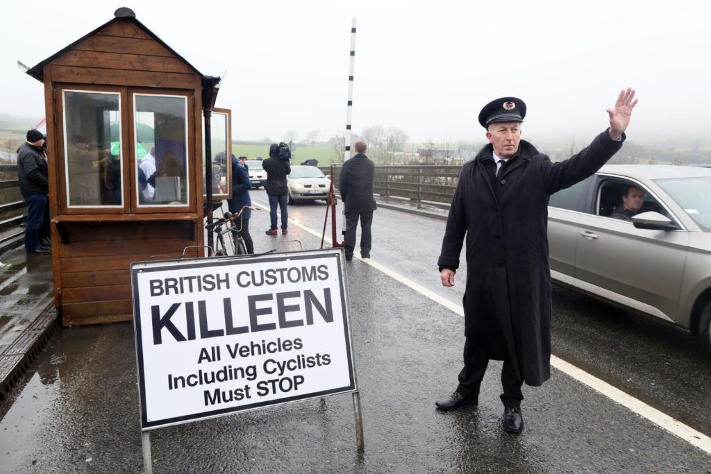 Demonstrators dressed as custom officials set up a mock customs checkpoint at the border crossing in Killeen, near Dundalk to protest against the potential introduction of border checks following the decision by the UK to leave the EU on February 18, 2017.

  / AFP PHOTO / Paul FAITH