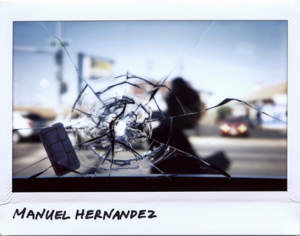 A person walks by a bullet hole in a restaurant window that is linked to the shooting of Manuel Hernandez, 30-year-old, taken at the 2700 block of West 51st Street in Chicago, Illinois on September 28, 2017.  
Hernandez was killed on September 21, 2017. These are the images of Chicago's murders -- ragedies playing out in the third largest American city in numbers unmatched by any other major US metropolis. Canadian photographer Jim Young spent six months chronicling the human toll of the runaway bloodshed plaguing the Midwest's capital and his adopted hometown, captured through images of memorials and murder scenes.
 / AFP PHOTO / JIM YOUNG