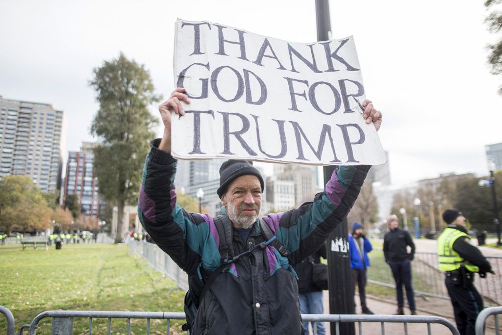 BOSTON, MA - NOVEMBER 18: A man holds a "Thank God For Trump" sign outside of an Alt-Right organized free speech event on the Boston Common on November 18, 2017 in Boston, Massachusetts. The "Rally for the Republic" event organized by conservative groups Resist Marxism and Boston Free Speech comes after thousands of counter-protesters shut down a similar demonstration in August.   Scott Eisen/Getty Images/AFP