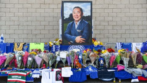 A portrait of Leicester City Football Club's Thai chairman Vichai Srivaddhanaprabha, who died in a helicopter crash at the club's stadium, is seen amid flowers and tributes outside the King Power Stadium in Leicester, eastern England, on October 29, 2018. - Leicester City's chairman Vichai Srivaddhanaprabha was among five people killed when his helicopter crashed and burst into flames in the Premier League side's stadium car park moments after taking off from the pitch, the club said on October 28. A stream of fans already fearing the worst had laid out flowers, football scarves and Buddhist prayers outside the club's King Power stadium after Saturday's accident in tribute to the Thai billionaire boss -- the man they credit for an against-all-odds Premier League victory in 2016 (Photo by Paul ELLIS / AFP)