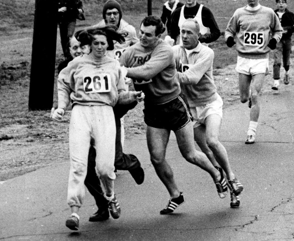 ASHLAND, MA - APRIL 19: Kathy Switzer roughed up by Jock Semple during Boston Mararthon. (Photo by Paul J. Connell/The Boston Globe via Getty Images)