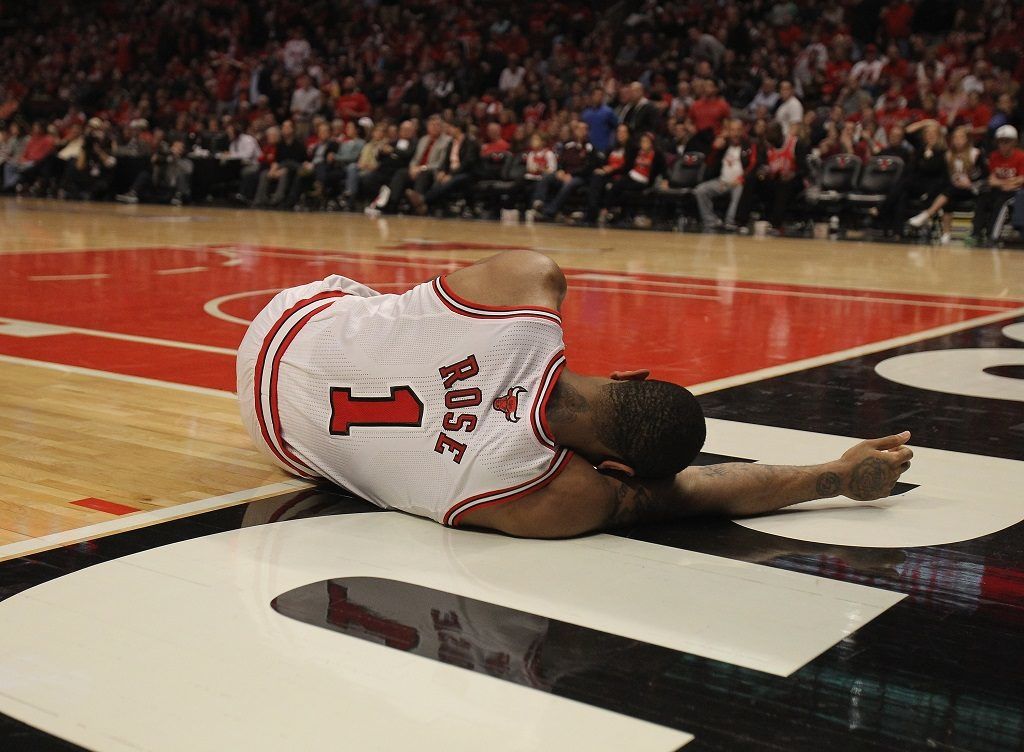 CHICAGO, IL - APRIL 28: Derrick Rose #1 of the Chicago Bulls lays on the floor aftrer suffering an injury against the Philadelphia 76ers in Game One of the Eastern Conference Quarterfinals during the 2012 NBA Playoffs at the United Center on April 28, 2012 in Chicago, Illinois. The Bulls defeated the 76ers 103-91. NOTE TO USER: User expressly acknowledges and agrees that, by downloading and or using this photograph, User is consenting to the terms and conditions of the Getty Images License Agreement. (Photo by Jonathan Daniel/Getty Images)