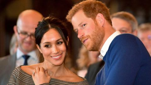 CARDIFF, WALES - JANUARY 18:  Prince Harry whispers to Meghan Markle as they watch a dance performance by Jukebox Collective in the banqueting hall during a visit to Cardiff Castle on January 18, 2018 in Cardiff, Wales. (Photo by Ben Birchall - WPA Pool / Getty Images)