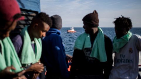 A group of minors, part of a group of 47 migrants stranded aboard the Dutch-flagged rescue vessel Sea Watch 3, are pictured as the vessel is anchored off Syracuse, Sicily, on January 26, 2019. - Save the Children on January 26, 2019 appealed to Italy to allow minors rescued in the Mediterranean to land, amid the latest diplomatic row over the fate of migrants saved at sea. The director of the Italian arm of Save the Children called for an "immediate" response to the call by Catania prosecutors to allow the minors on board the Dutch-flagged rescue ship Sea Watch 3, currently sheltering from bad weather off Sicily, to be disembarked. (Photo by FEDERICO SCOPPA / AFP)