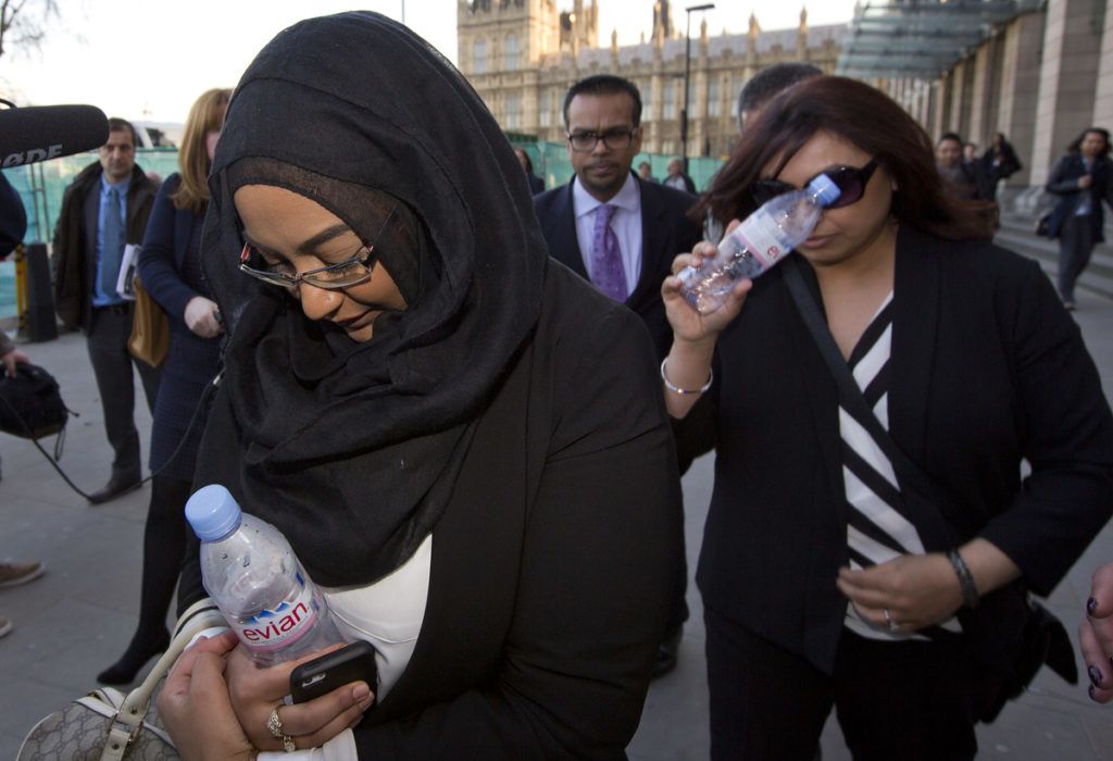 Sahima Begum (L), older sister of Shamima Begum and Fahmida Aziz (R), first cousin to Khadija Sultana, leave the House of Commons Home Affairs Committee, after giving evidence on the background and details leading to the disappearance of the three schoolgirls who fled their London homes for the conflict in Syria, in central London on March 10, 2015. AFP PHOTO / JUSTIN TALLIS (Photo by JUSTIN TALLIS / AFP)