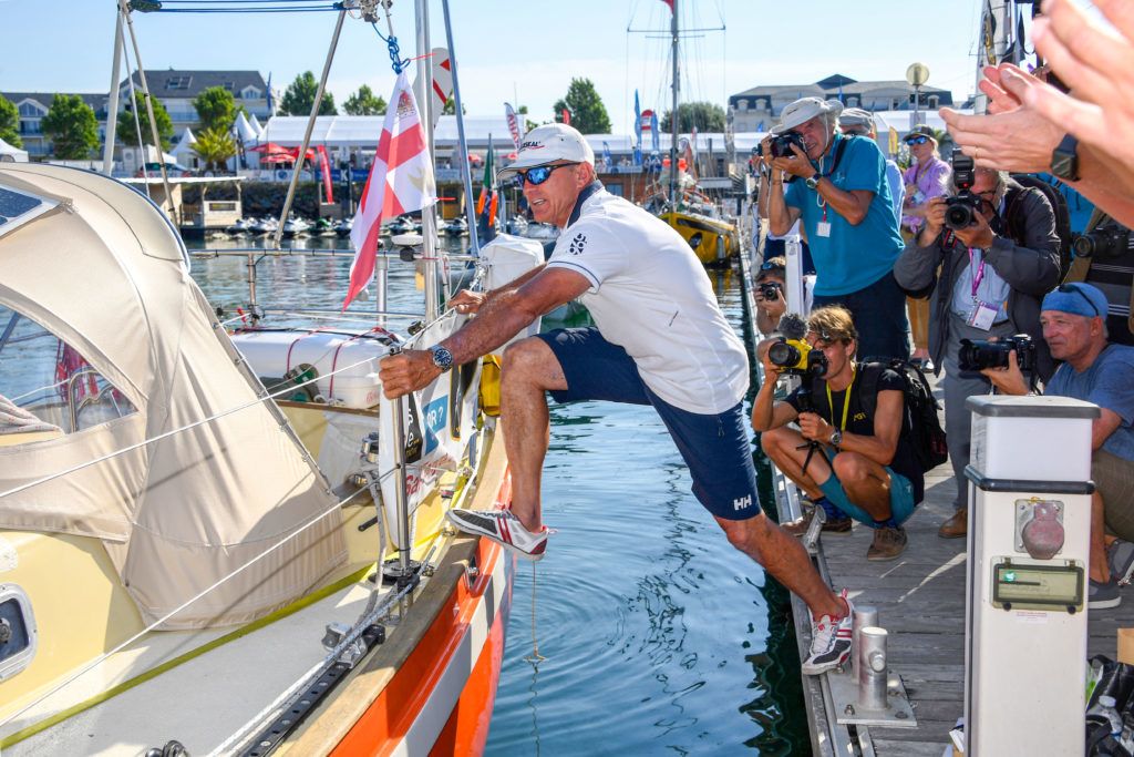 Hungarian born, US skipper, Istvan Kopar climbs on board on his boat "Puffin" in Les Sables d'Olonne Harbour on July 1, 2018, at the start of the solo around-the-world "Golden Globe Race" ocean race in which sailors compete without high technology aides such as GPS or computers. (Photo by Damien MEYER / AFP)