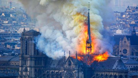 Smoke and flames rise during a fire at the landmark Notre-Dame Cathedral in central Paris on April 15, 2019, potentially involving renovation works being carried out at the site, the fire service said. - A major fire broke out at the landmark Notre-Dame Cathedral in central Paris sending flames and huge clouds of grey smoke billowing into the sky, the fire service said. The flames and smoke plumed from the spire and roof of the gothic cathedral, visited by millions of people a year, where renovations are currently underway. (Photo by Hubert Hitier / AFP)
