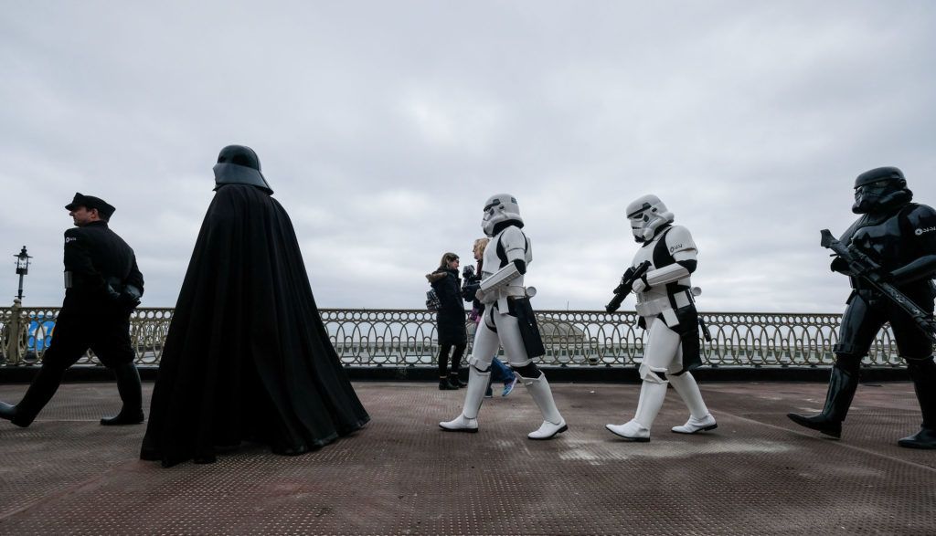 SCARBOROUGH, ENGLAND - APRIL 06: Darth Vader and his Stormtroopers walk among fans on the first day of the Scarborough Sci-Fi weekend at the seafront Spa Complex on April 06, 2019 in Scarborough, England. The North Yorkshire seaside town of Scarborough hosts the event for the sixth year and brought many areas of Sci-Fi fandom to entertain visitors and enthusiasts including guest star appearances, panel discussions, gaming, cosplay, props, comic books and merchandise stalls with many of those attending wearing costumes and outfits of their favourite Sci-Fi characters. (Photo by Ian Forsyth/Getty Images)