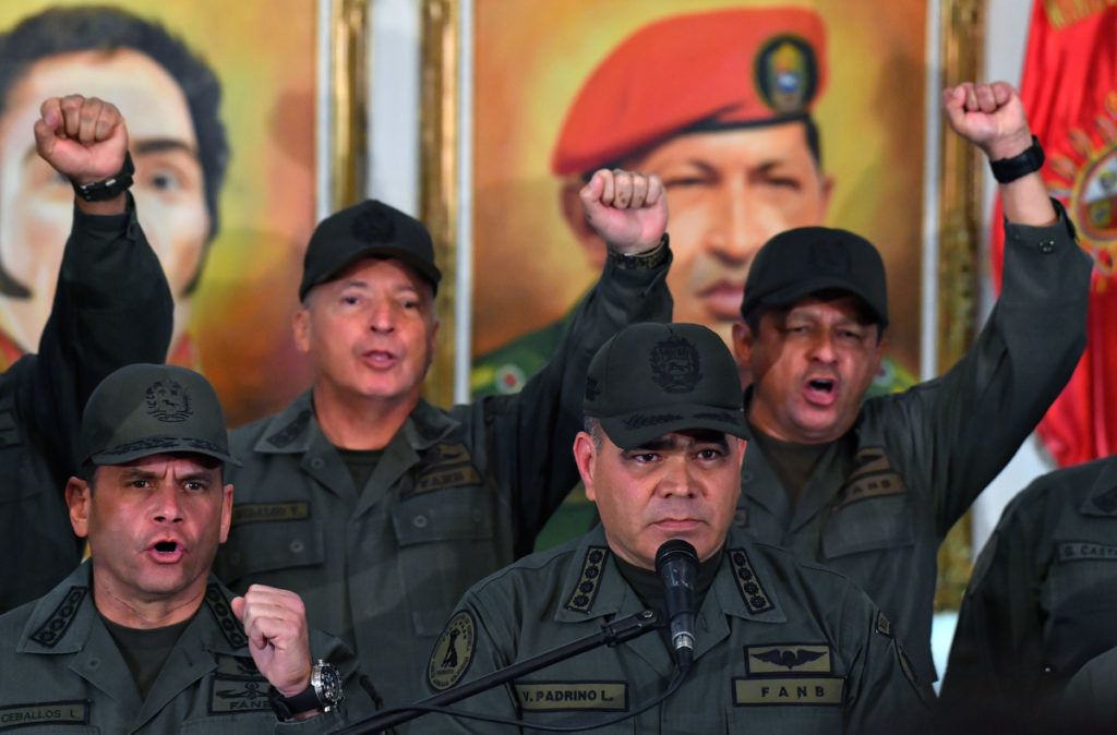 Venezuelan Defense Minister Vladimir Padrino (R) gestures surrounded by military men as he delivers a speech in Caracas on February 19, 2019. (Photo by Yuri CORTEZ / AFP)