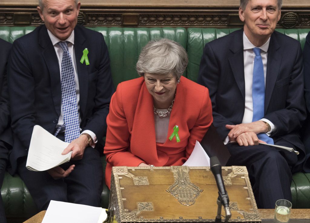 A handout photograph taken and released by the UK Parliament on May 15, 2019 shows Britain's Prime Minister Theresa May (C), reacting during the weekly Prime Minister's Questions (PMQs) question and answer session in the House of Commons in London. (Photo by JESSICA TAYLOR / UK PARLIAMENT / AFP) / EDITORS NOTE THE IMAGE HAS BEEN DIGITALLY ALTERED AT SOURCE TO OBSCURE VISIBLE DOCUMENTS  - RESTRICTED TO EDITORIAL USE - NO USE FOR ENTERTAINMENT, SATIRICAL, ADVERTISING PURPOSES - MANDATORY CREDIT " AFP PHOTO /JESSICA TAYLOR/ UK Parliament"