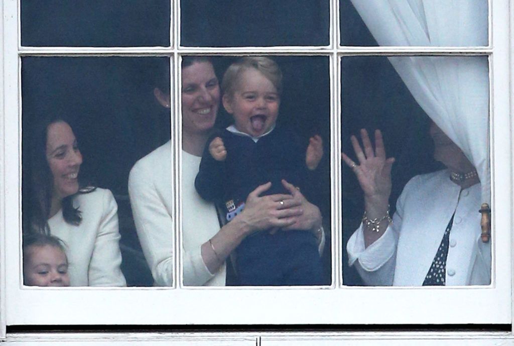 LONDON, ENGLAND - JUNE 13:  Prince George of Cambridge is held by his nanny Maria Teresa Turrion Borrallo as he waves from the window of Buckingham Palace as he watches the Trooping The Colour ceremony on June 13, 2015 in London, England. The ceremony is Queen Elizabeth II's annual birthday parade and dates back to the time of Charles II in the 17th Century, when the Colours of a regiment were used as a rallying point in battle.  (Photo by Chris Jackson/Getty Images)