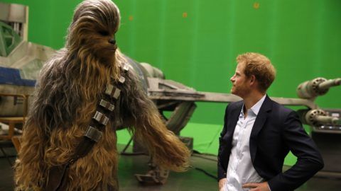 IVER HEATH, ENGLAND - APRIL 19: Prince Harry (R) meets Chewbacca during a tour of the Star Wars sets at Pinewood studios on April 19, 2016  in Iver Heath, England. Prince William and Prince Harry are touring Pinewood studios to visit the production workshops and meet the creative teams working behind the scenes on the Star Wars films. (Photo by Adrian Dennis-WPA Pool/Getty IMages)