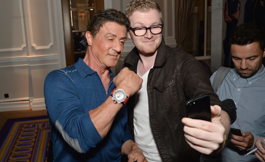 LONDON, ENGLAND - AUGUST 04:  Sylvester Stallone poses with a fan as he attends "The Expendables 3" press conference at the Corinthia Hotel London on August 4, 2014 in London, England. The Expendables 3 is released on August 14, 2014.  (Photo by Dave J Hogan/Getty Images for Lionsgate)