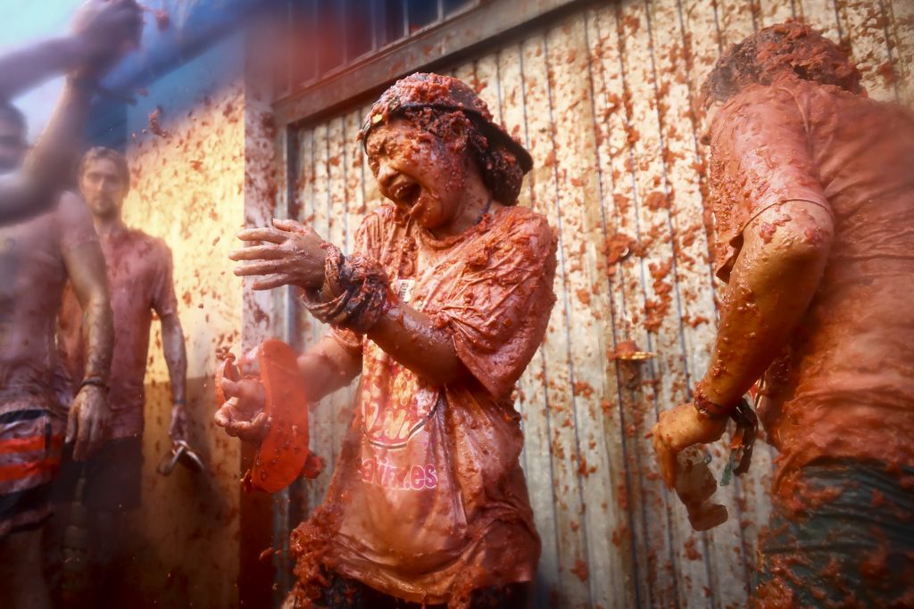 Revellers are covered with smashed tomato puree during the 'Tomatina' festival in Bunol, Valencia, Spain, on 28 August 2019. This iconic annual fiesta that takes place on the last Wednesday of August and celebrates its 74rd edition has been billed as "the world's biggest food fight" becoming a major draw for foreigners, in particular from Britain, Japan and the United States. (Photo by Jose Miguel Fernandez/NurPhoto)