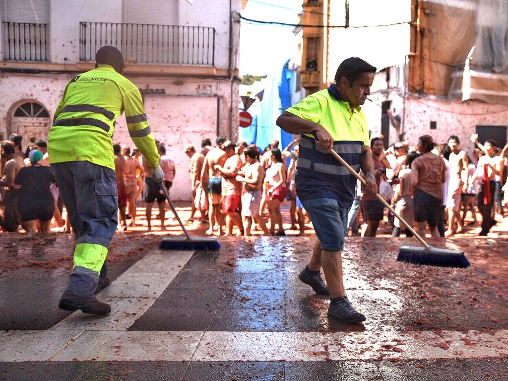 VALENCIA, SPAIN - AUGUST 28: Two cleaning workers are seen cleaning the street covered by the remains of the tomatoes during the festival of ÔLa TomatinaÕ in Bu–ol on August 28, 2019 in Valencia, Spain. (Photo by Jorge Gil/Europa Press via Getty Images)  (Photo by Europa Press News/Europa Press via Getty Images)