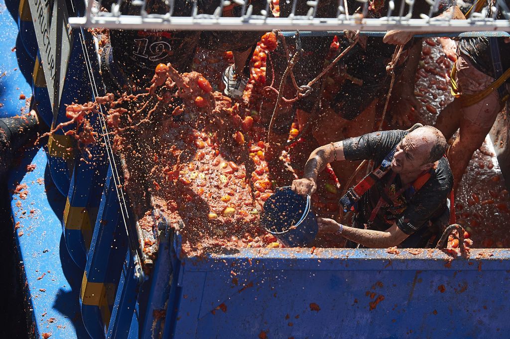 BUNOL, SPAIN - AUGUST 28: People play around a Tomato Fight during Tomatina Festival on August 28, 2019 in Bunol, Spain. The Tomatina Festival began in 1945 but was forbidden during the Franco Regime during a few years. In 2018 around 65% of the 22,000 revelers were foreign throwing around 150 tonnes of ripe tomatoes and the two rules state only tomatoes may be thrown and that they must be squashed before launch. (Photo by Borja B. Hojas/Getty Images)