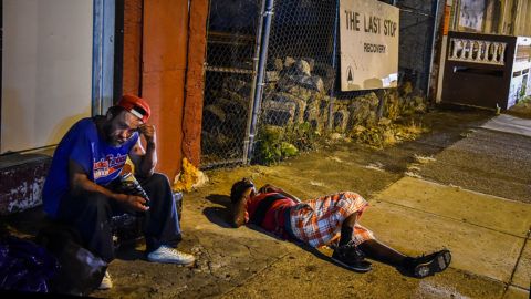 PHILADELPHIA, PA - JULY 20: Art Gutierrez, 42, left, sits at a store front steps across from The Last Stop on Thursday, July 20, 2017, in Philadelphia, PA. Gutierrez who grew up in California, has been using heroin for two year and during that these two years he has contracted HIV and Hep C. He also watched a friend die from a lethal dose of fentanyl. He sells clean needles called works to support his habit. (Photo by Salwan Georges/The Washington Post via Getty Images)