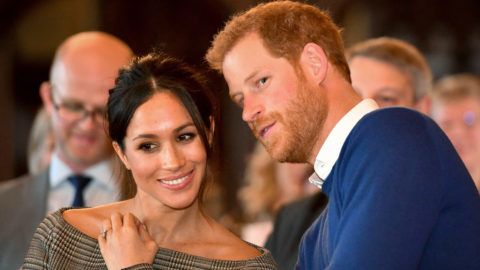 CARDIFF, WALES - JANUARY 18:  Prince Harry whispers to Meghan Markle as they watch a dance performance by Jukebox Collective in the banqueting hall during a visit to Cardiff Castle on January 18, 2018 in Cardiff, Wales. (Photo by Ben Birchall - WPA Pool / Getty Images)